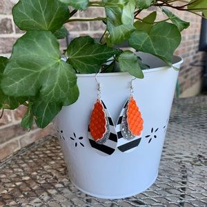 Orange, black and white, and silver tear drop